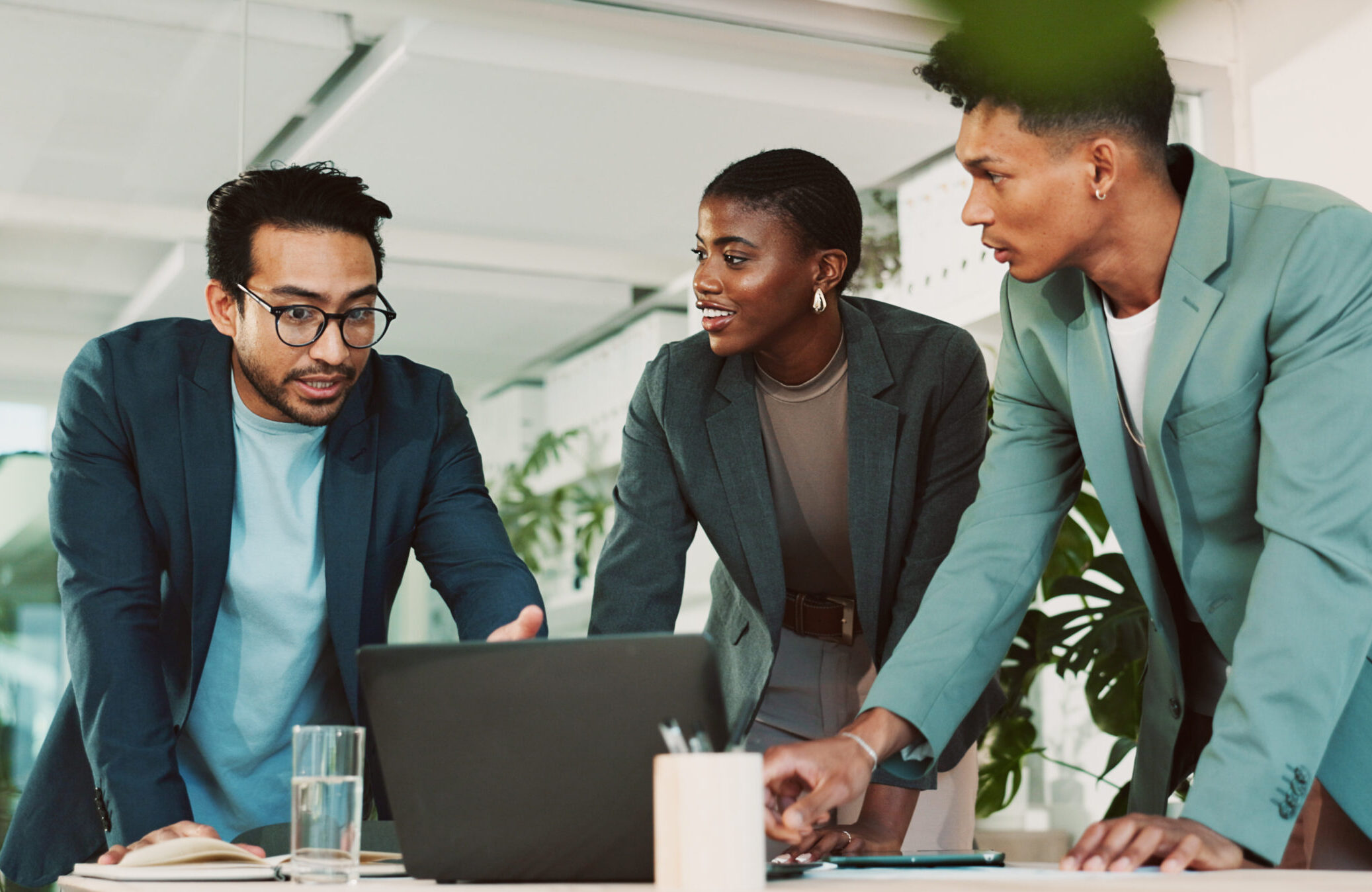 Office, teamwork and business people with laptop for discussion, financial planning and investment. Collaboration, employees and advisor in accounting firm for market performance, feedback or digital